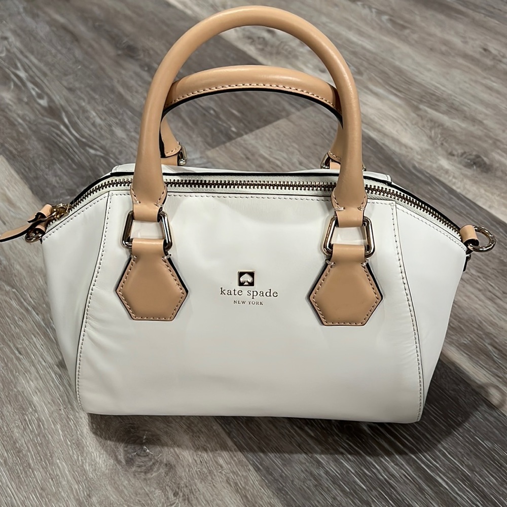Kate Spade white leather handbag with papers